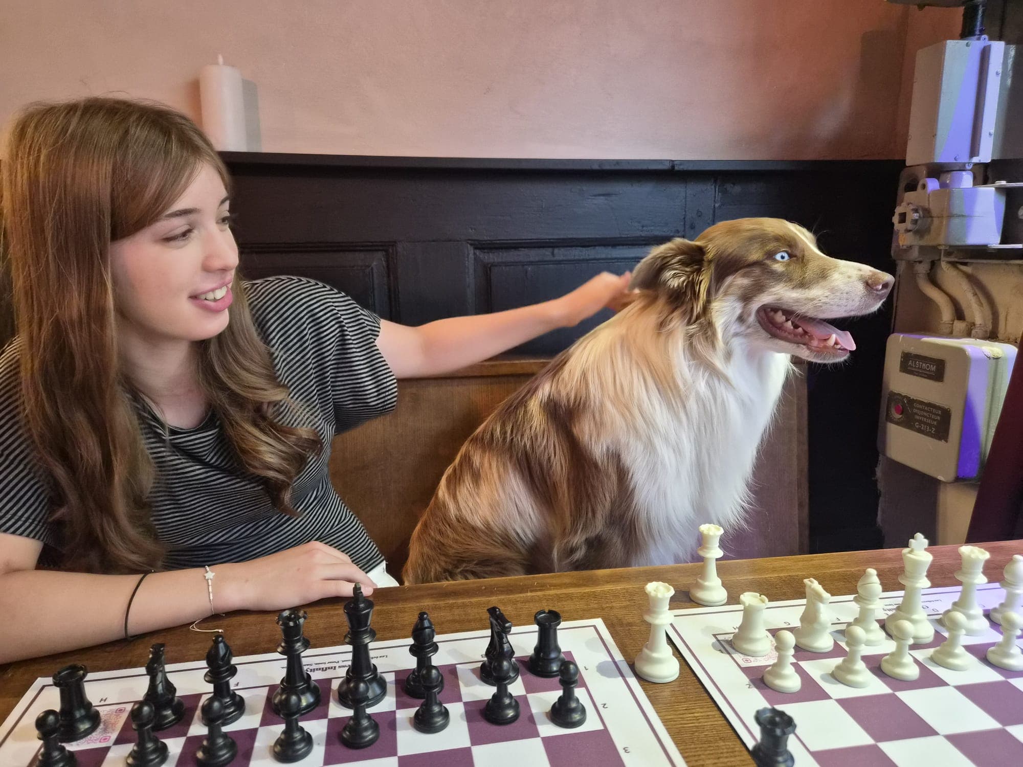 Margot avec la mascotte du club devant deux échiquiers